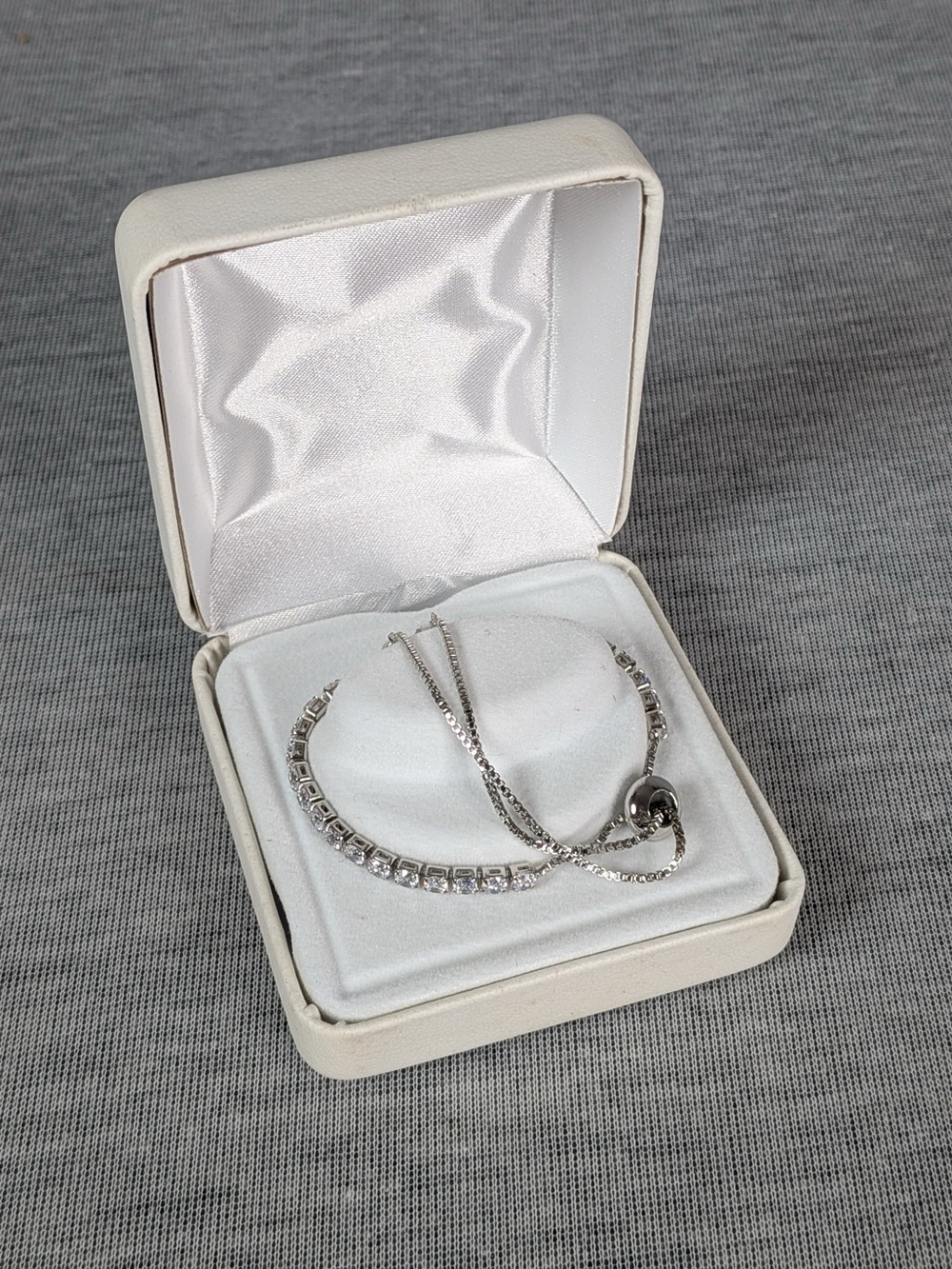 Silver tone adjustable tennis style bolo/slider bracelet